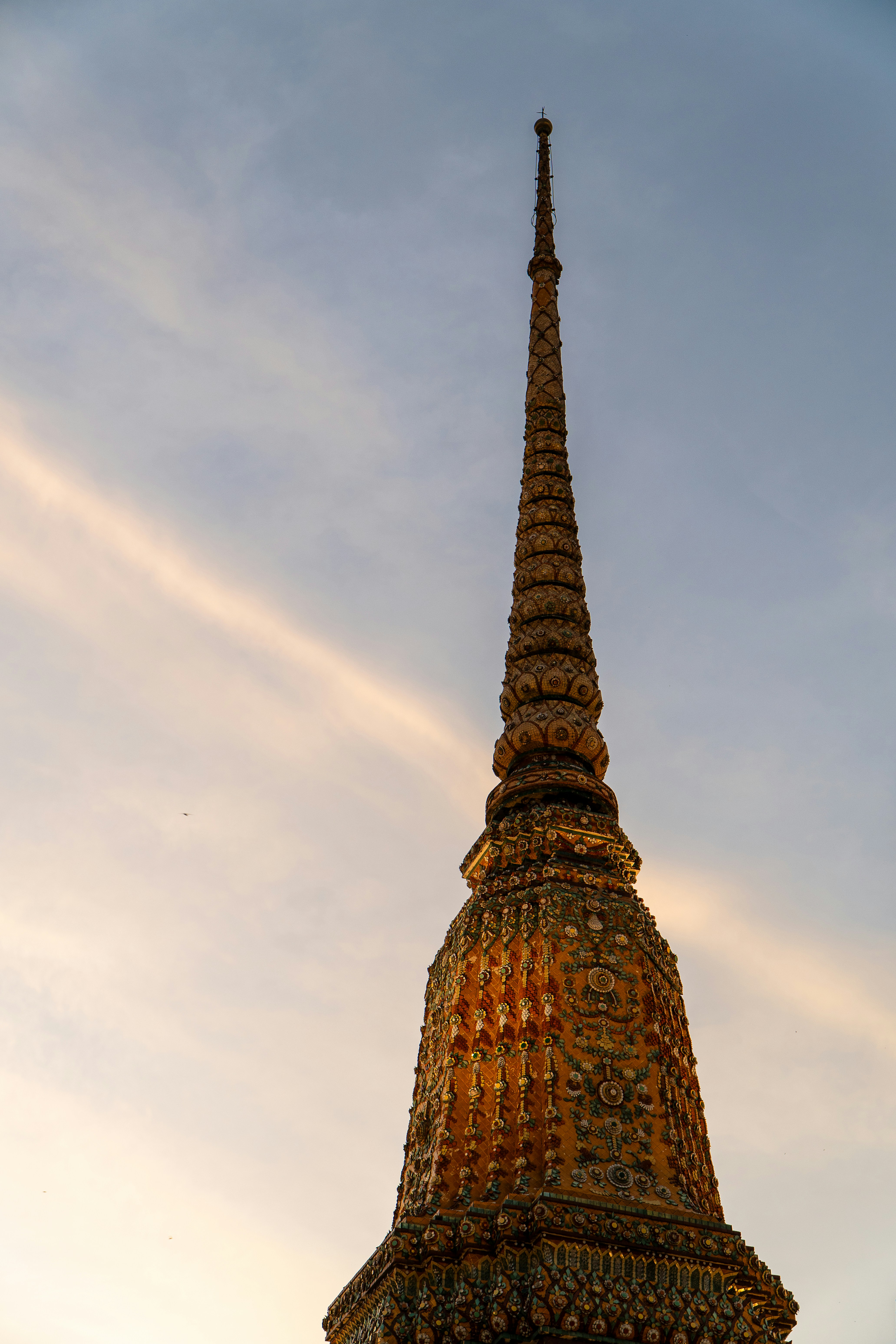 A very tall tower with a clock on it's side