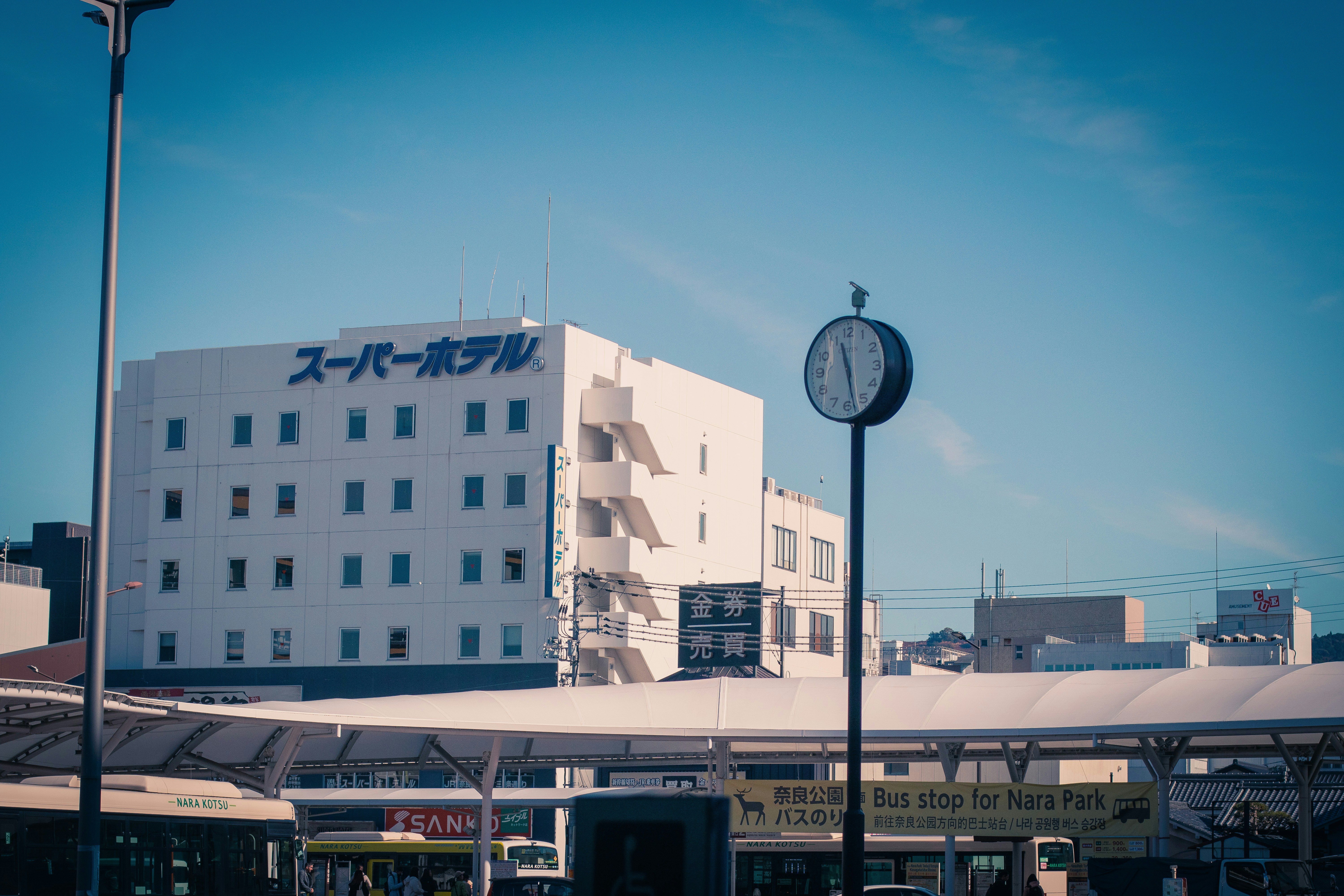 A large white building with a clock in front of it