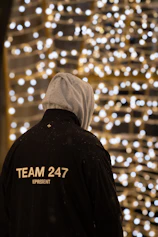 A person standing in front of a wall of lights