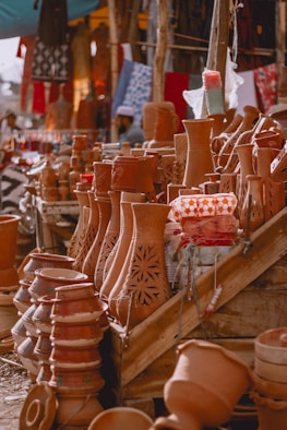 A lot of clay pots that are on a table