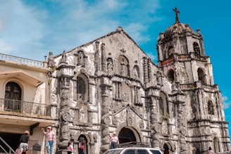 A car parked in front of an old church