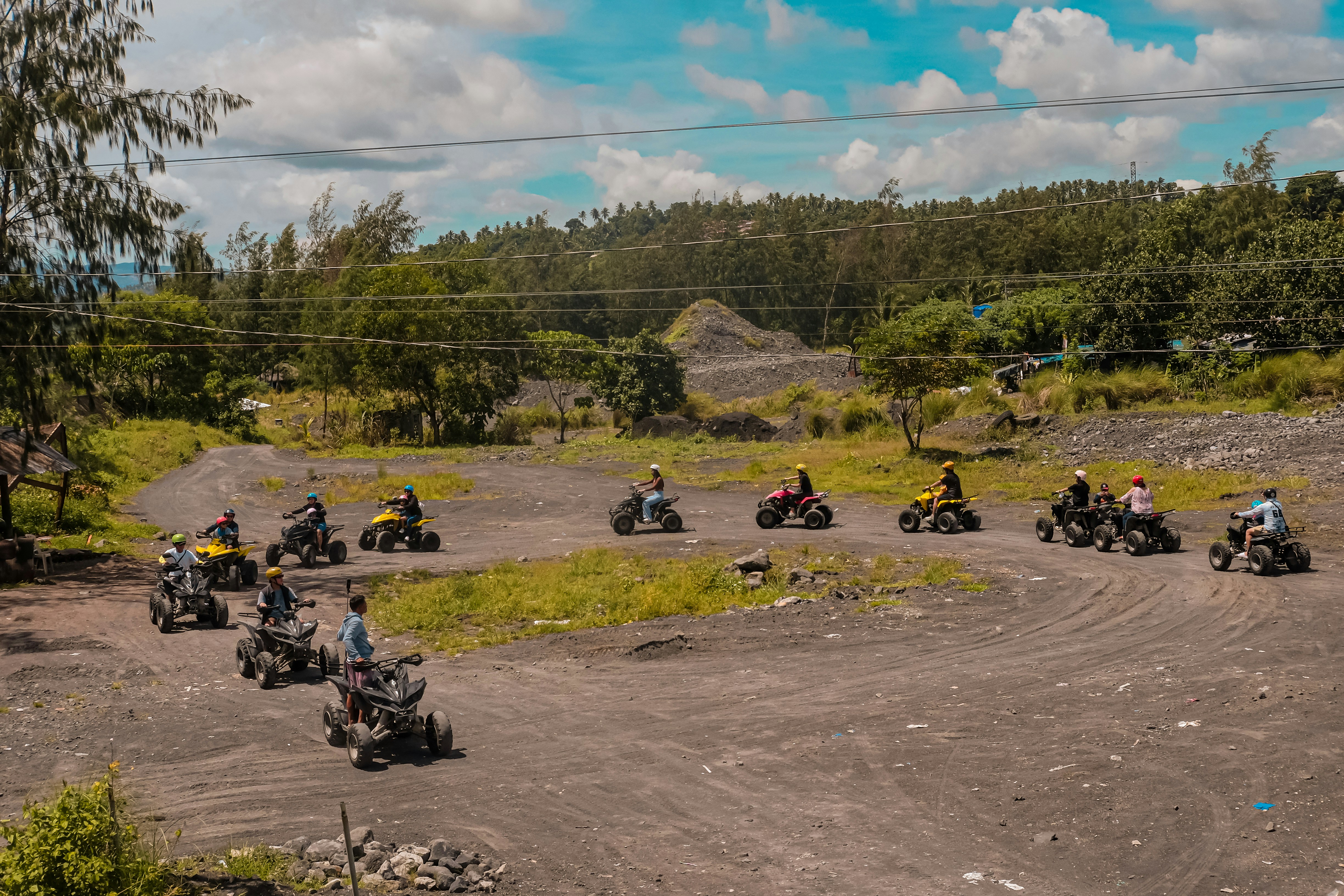 A group of people riding on the backs of four wheelers