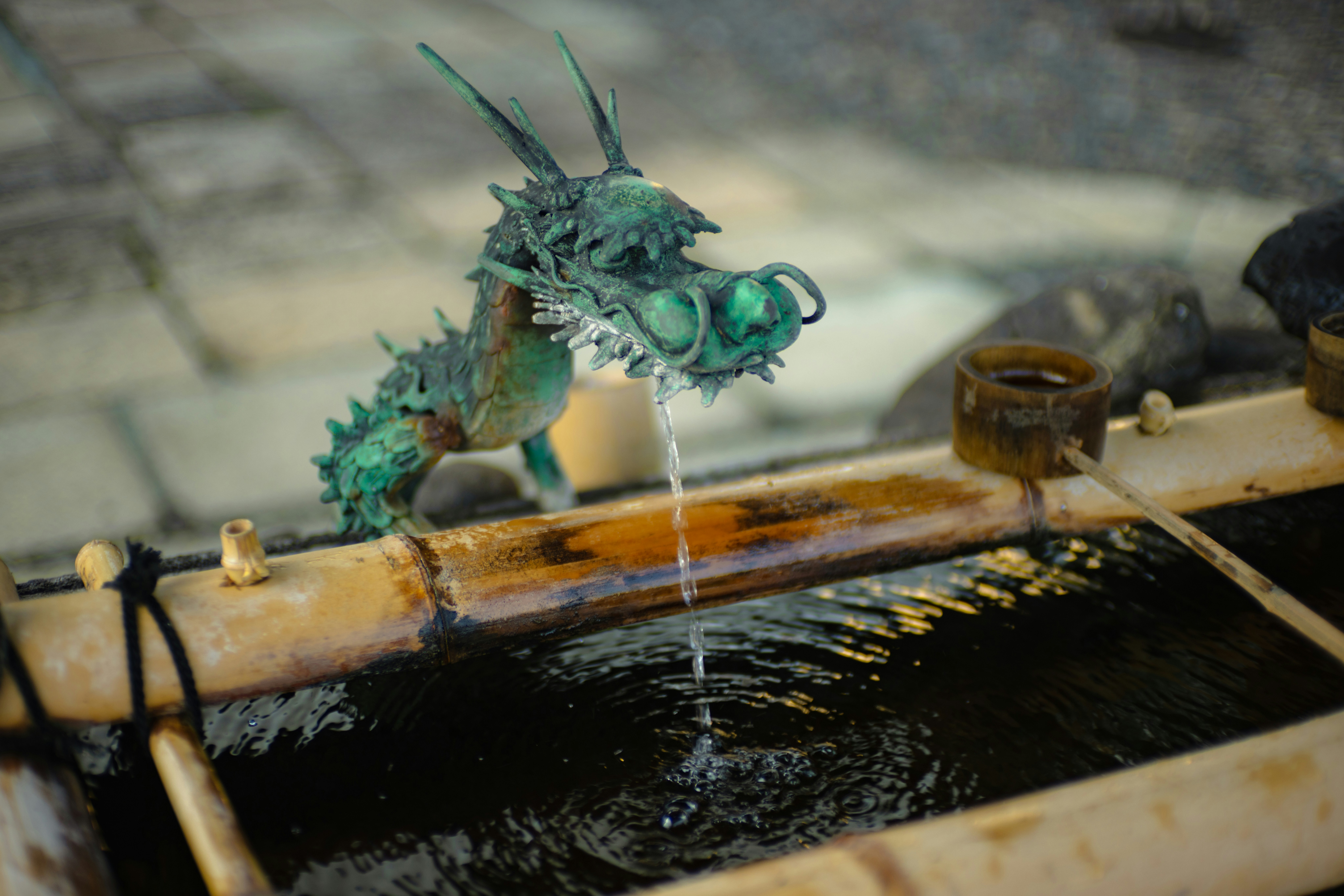 A close up of a water fountain with a dragon statue