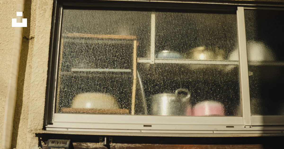 A window with pots and pans in it photo – Free Person Image on Unsplash