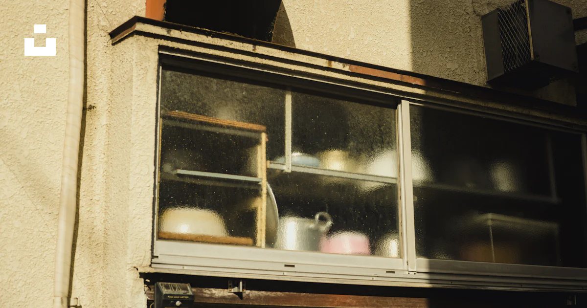 A window with pots and pans on it photo – Free Building Image on Unsplash