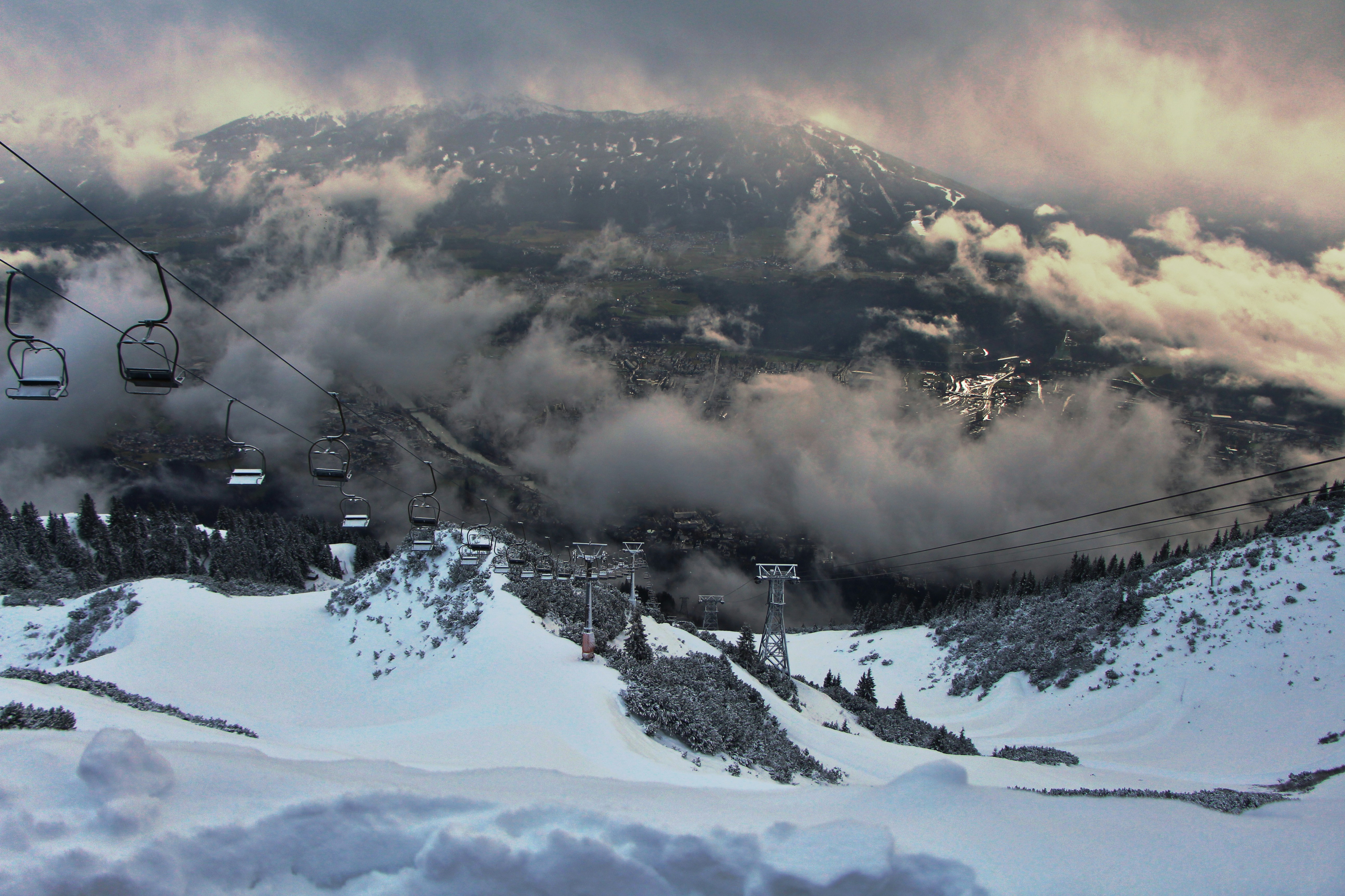 A ski lift going up a snowy mountain