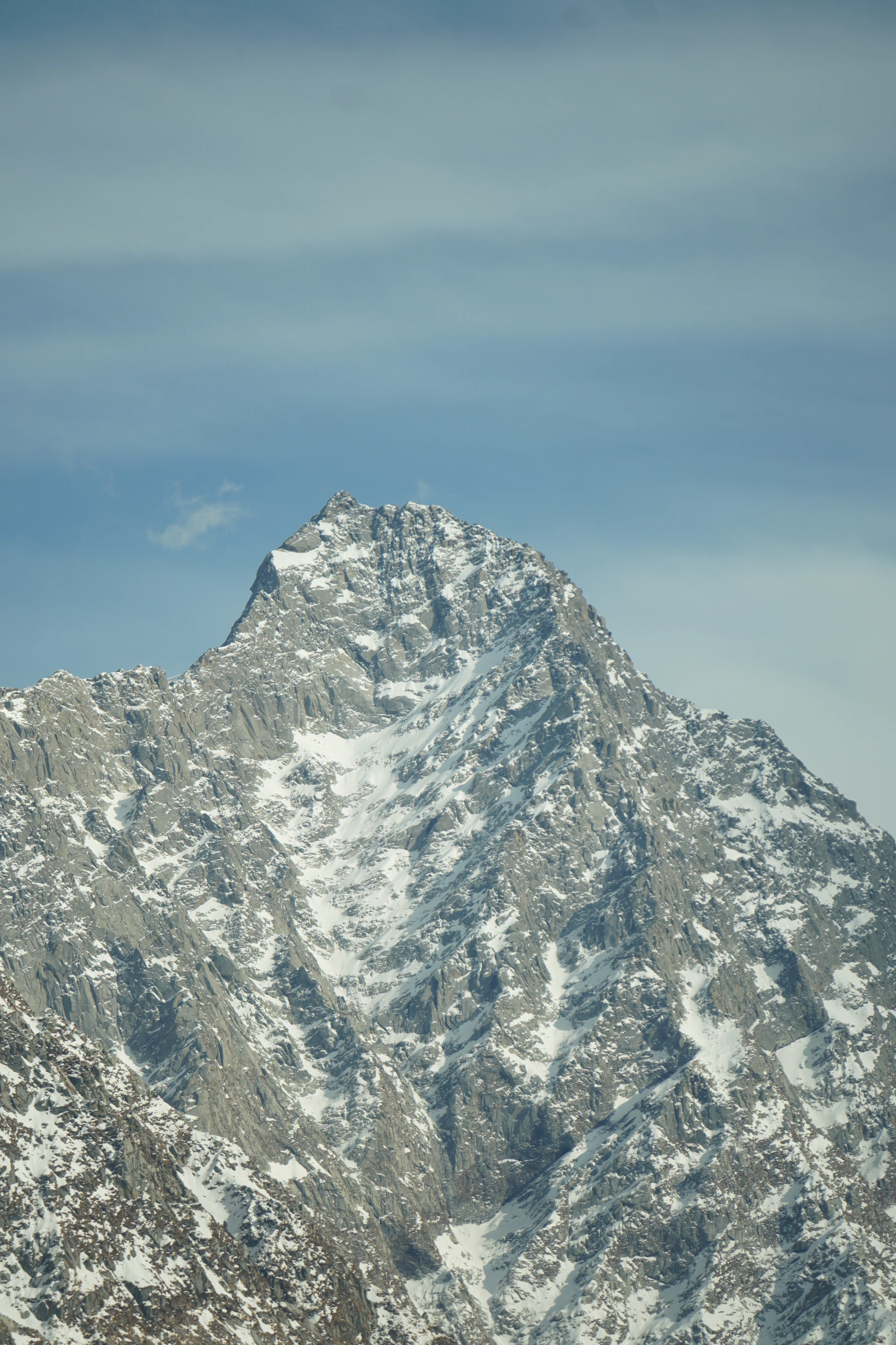 A snow covered mountain with a blue sky in the background
