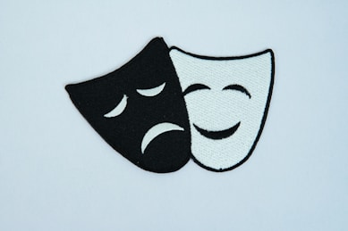 A black and white mask with a sad face