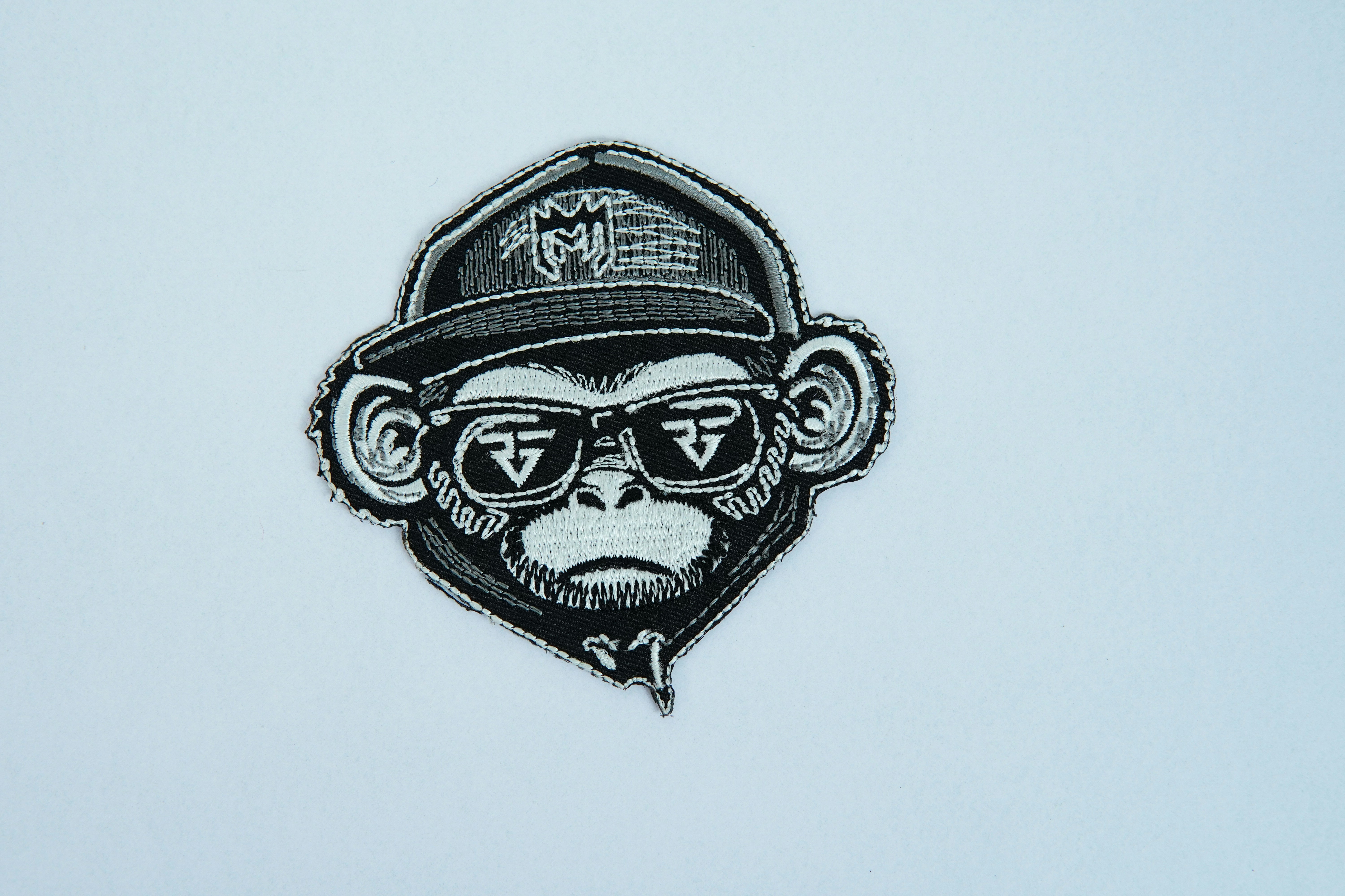 A picture of a monkey wearing a hat and sunglasses