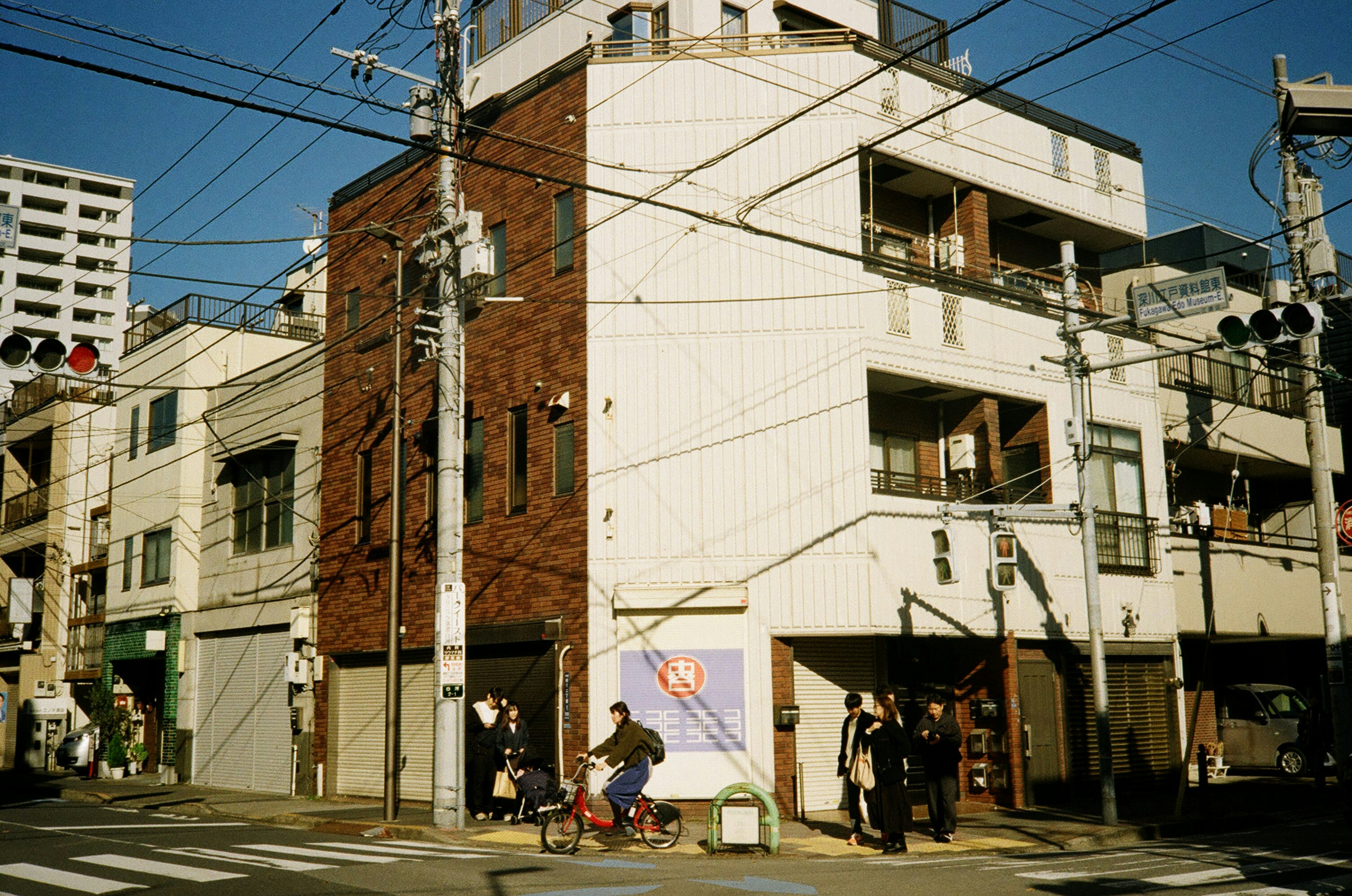 A tall white building sitting on the side of a road