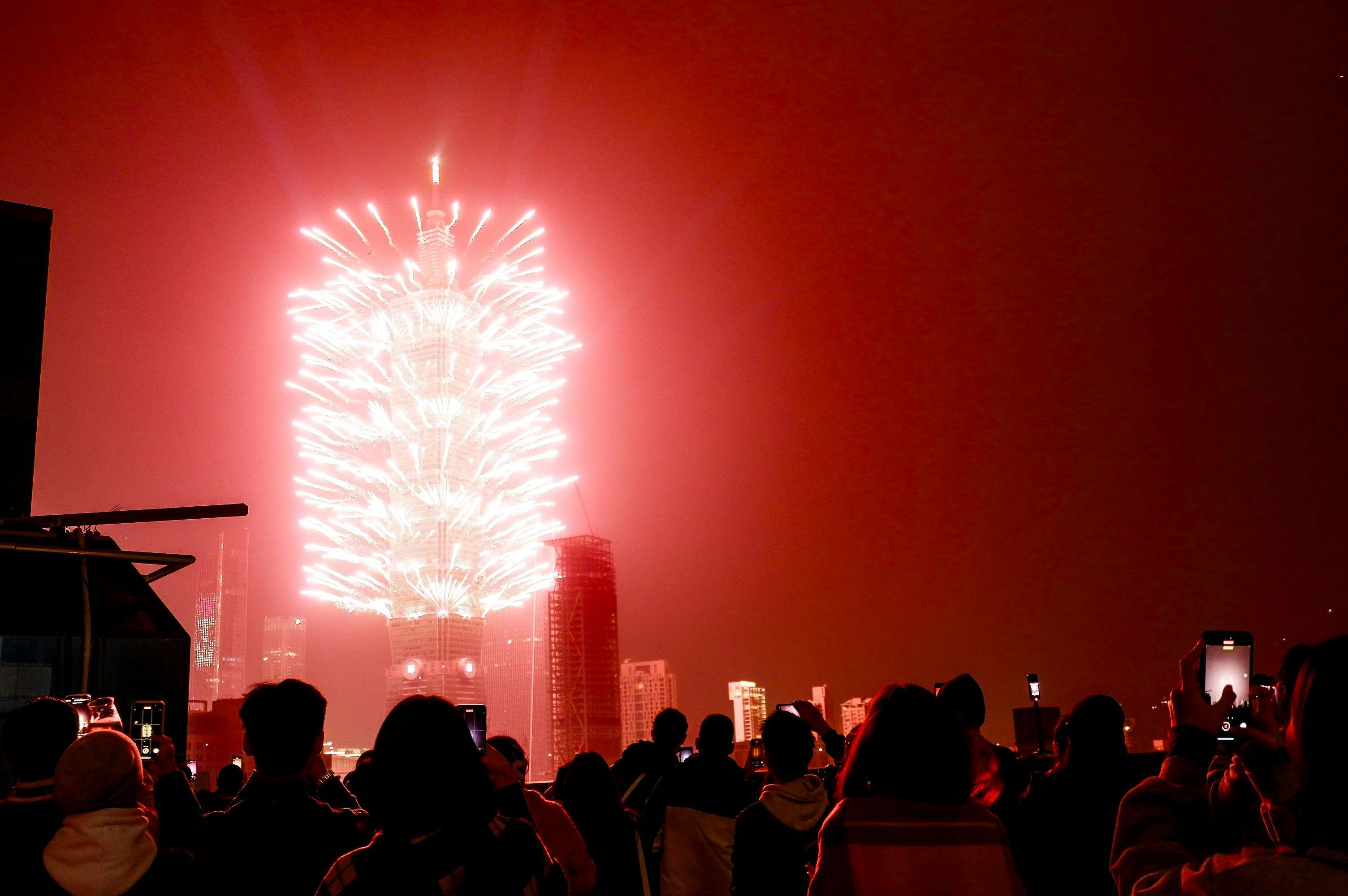 A crowd of people standing around a fireworks display