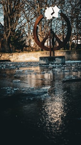 A large peace sign sitting in the middle of a river