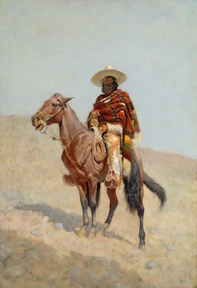 Man in hat and poncho rides a horse