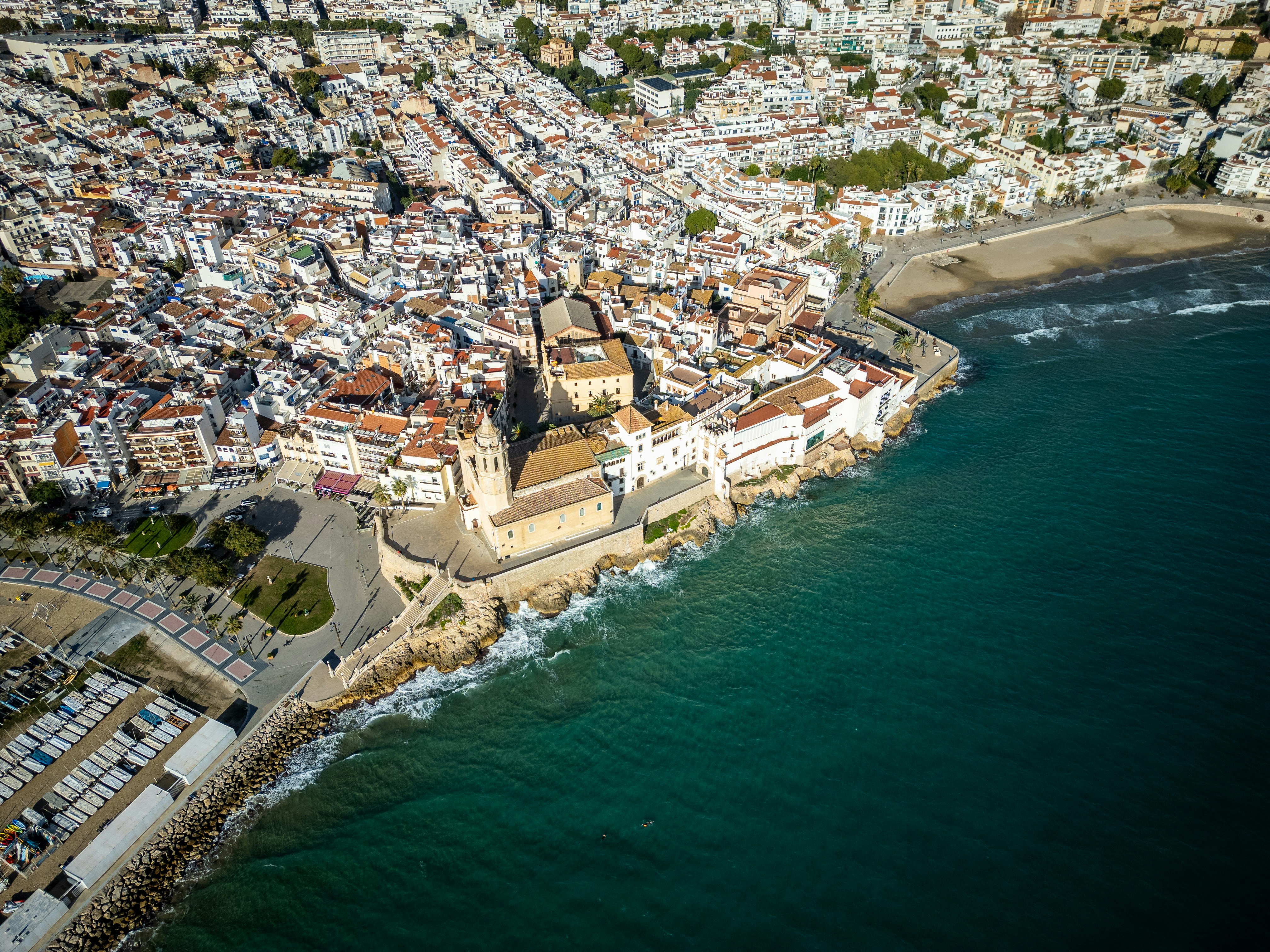 An aerial view of a city next to the ocean, Sitges, near Barcelona