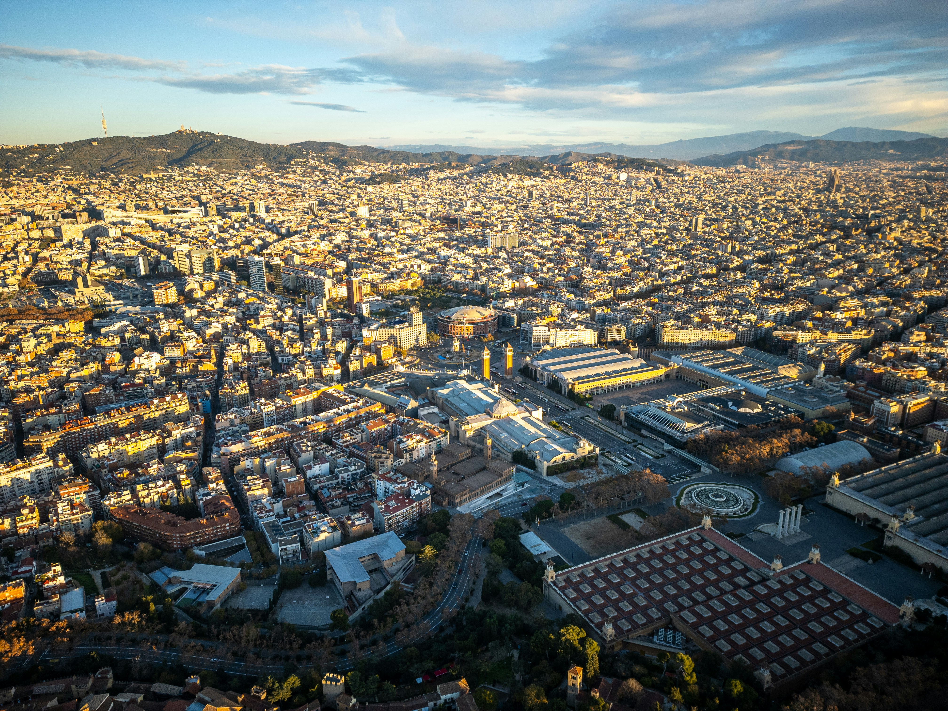 An aerial view of a city with mountains in the background