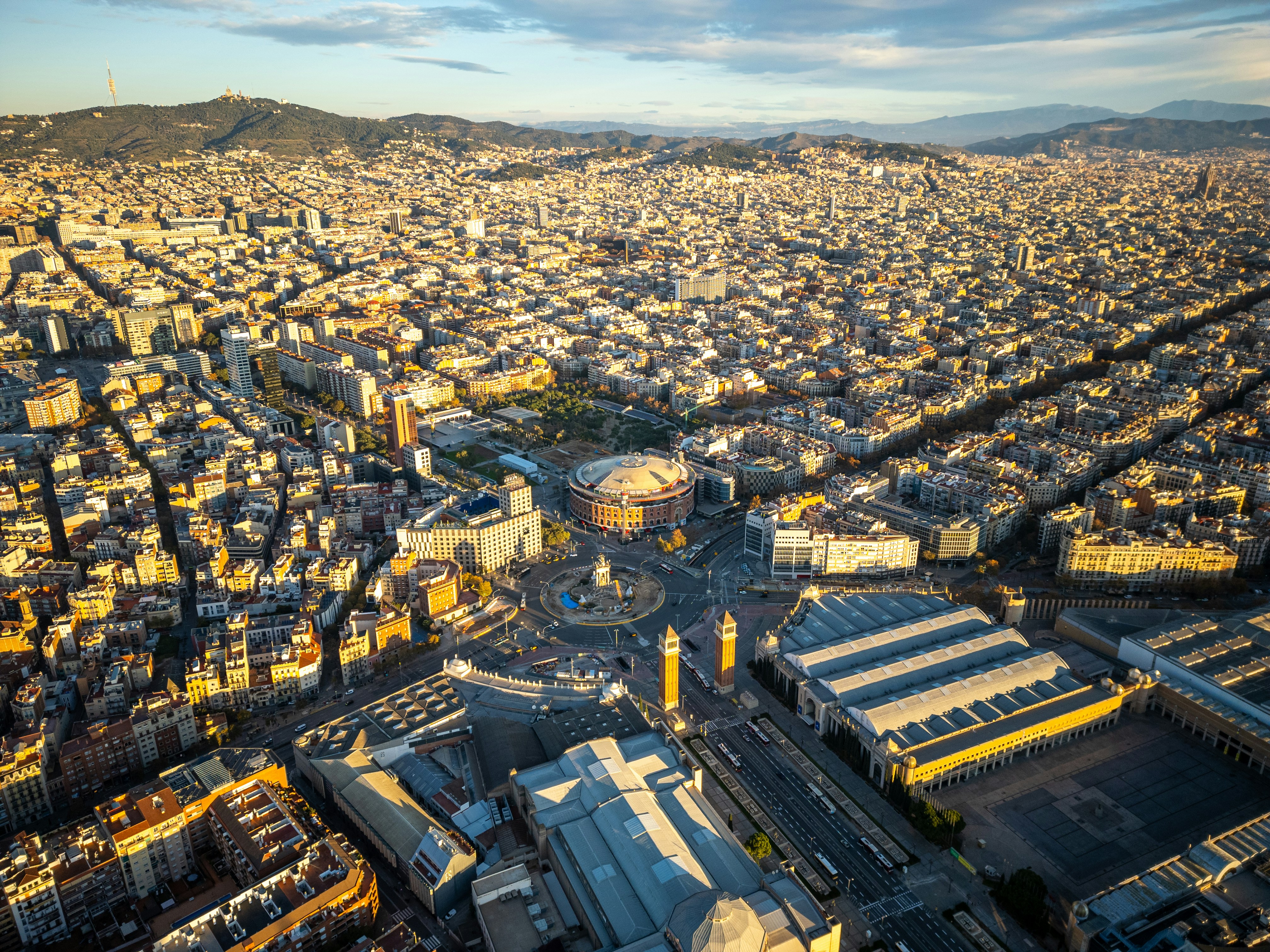 An aerial view of a city with mountains in the background