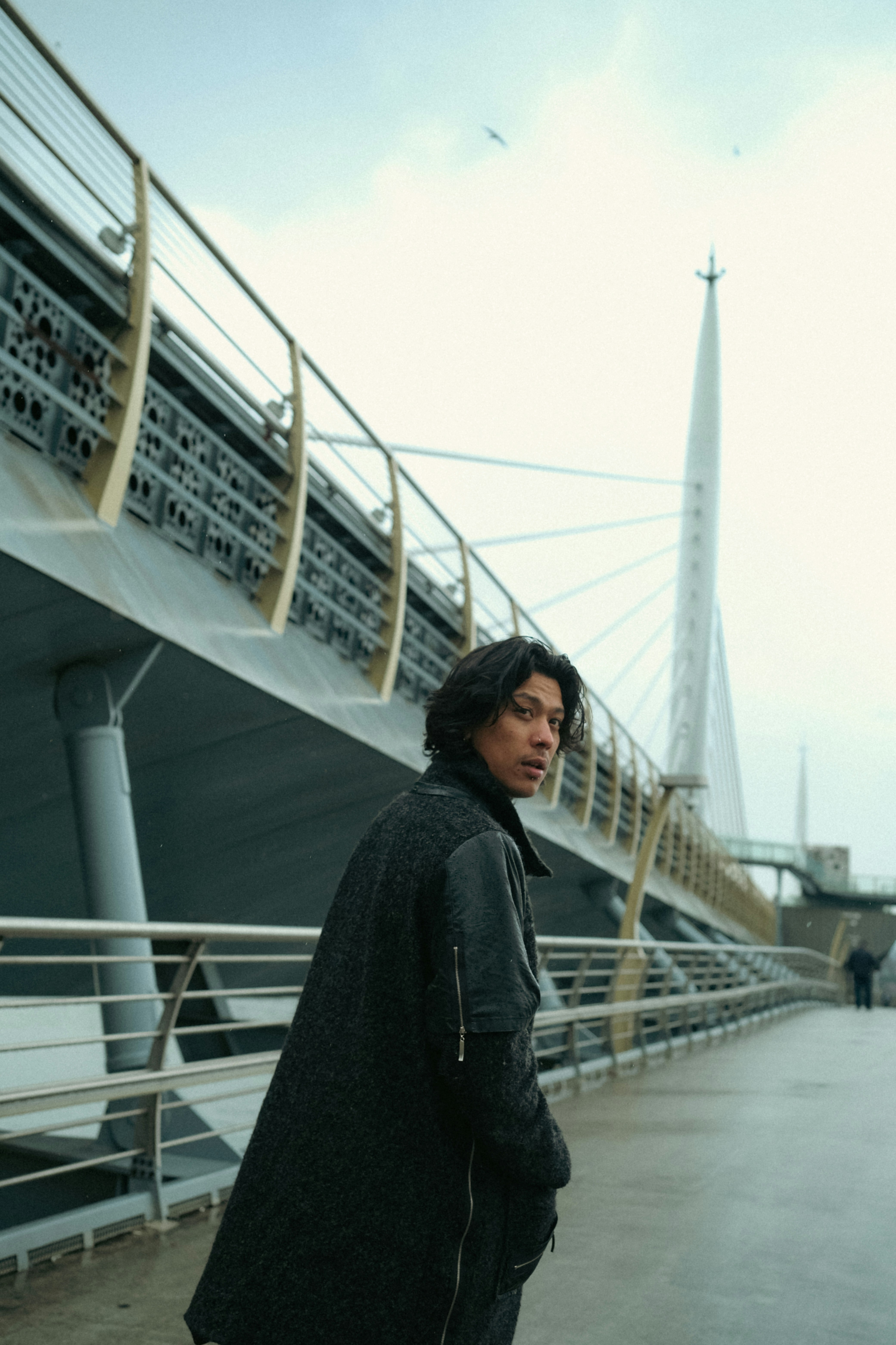 A man standing on a pier next to a boat
