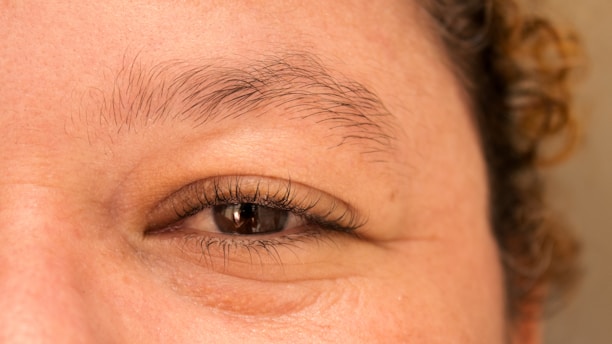 A close up of a woman's brown eyes