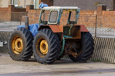 A large tractor parked on the side of a road on tractor tyres sold at tyrepublic in lagos nigeria