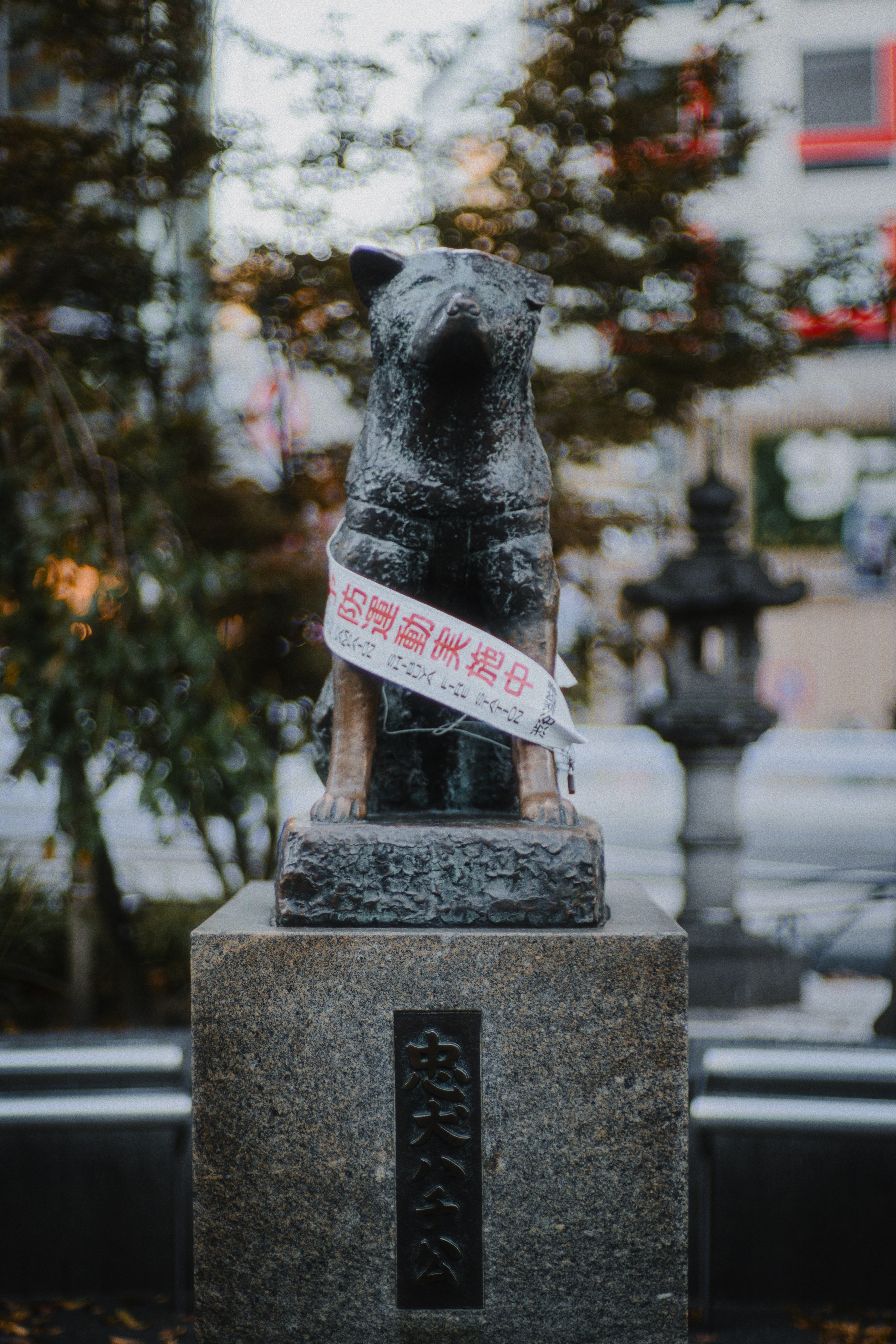 A statue of a dog with a ribbon around its neck