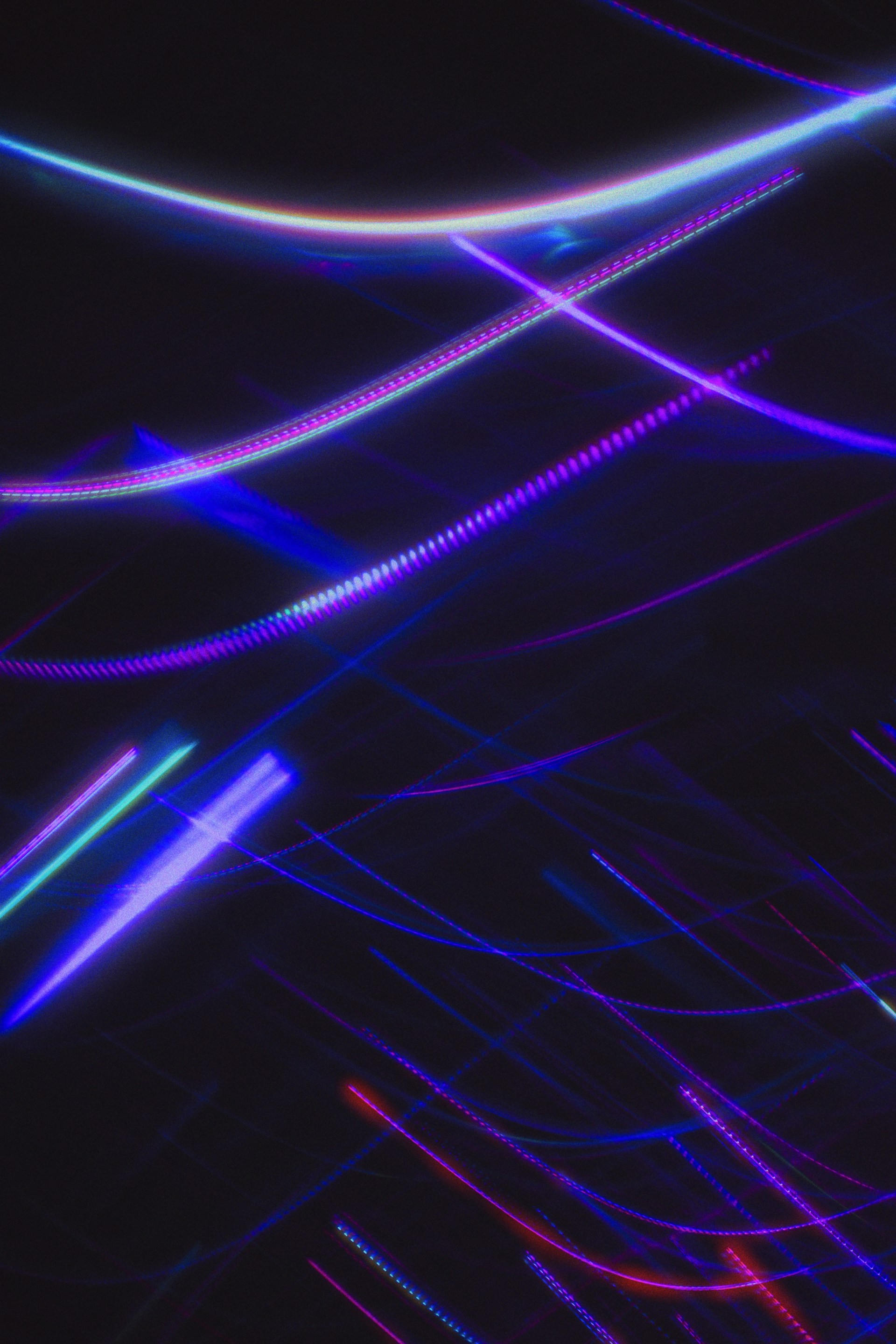 A black background with blue and pink lines