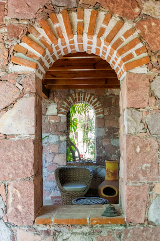 A window in a stone wall with a basket on it