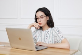 A woman sitting in front of a laptop computer