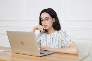 A woman sitting in front of a laptop computer
