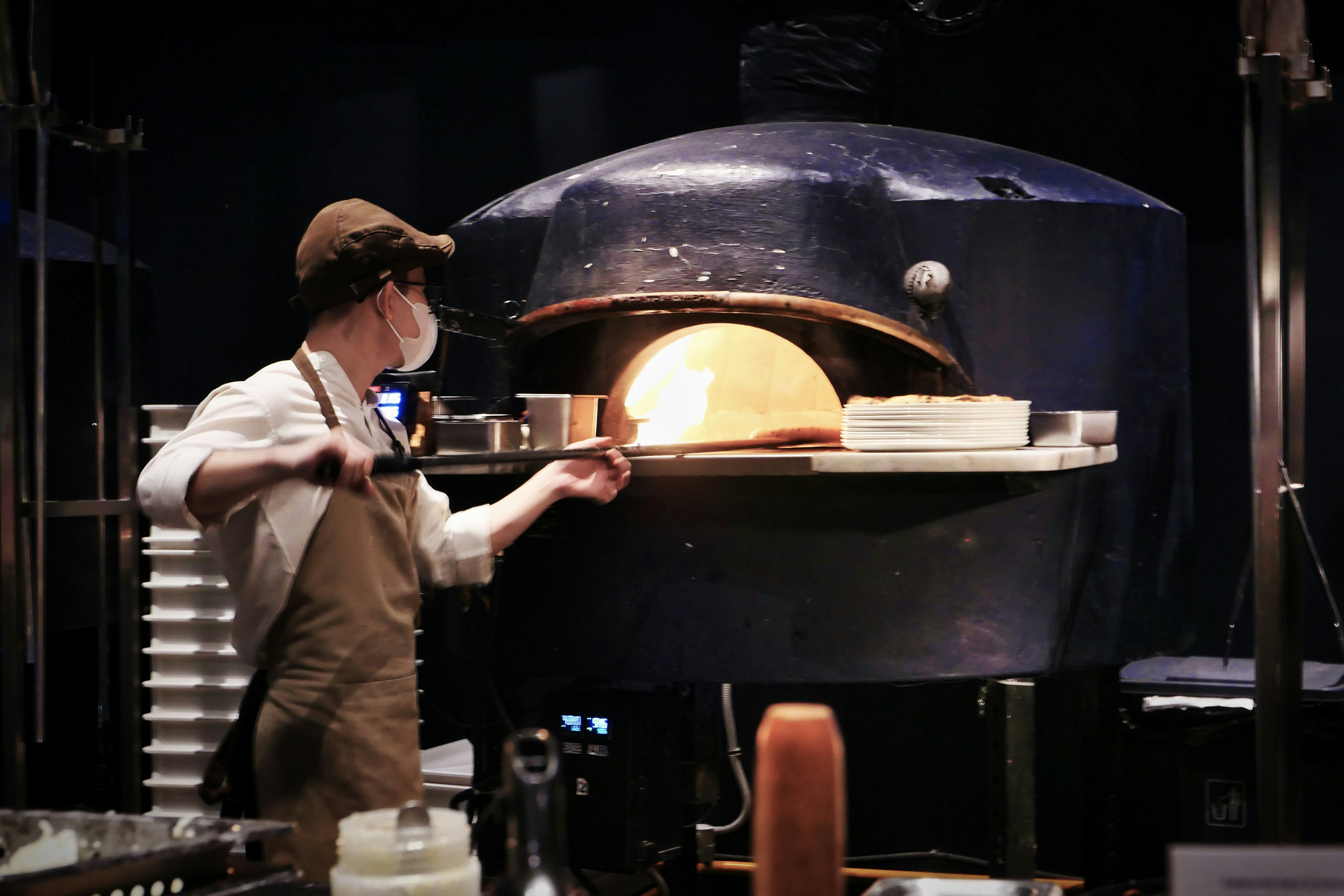 A man standing in front of a large oven
