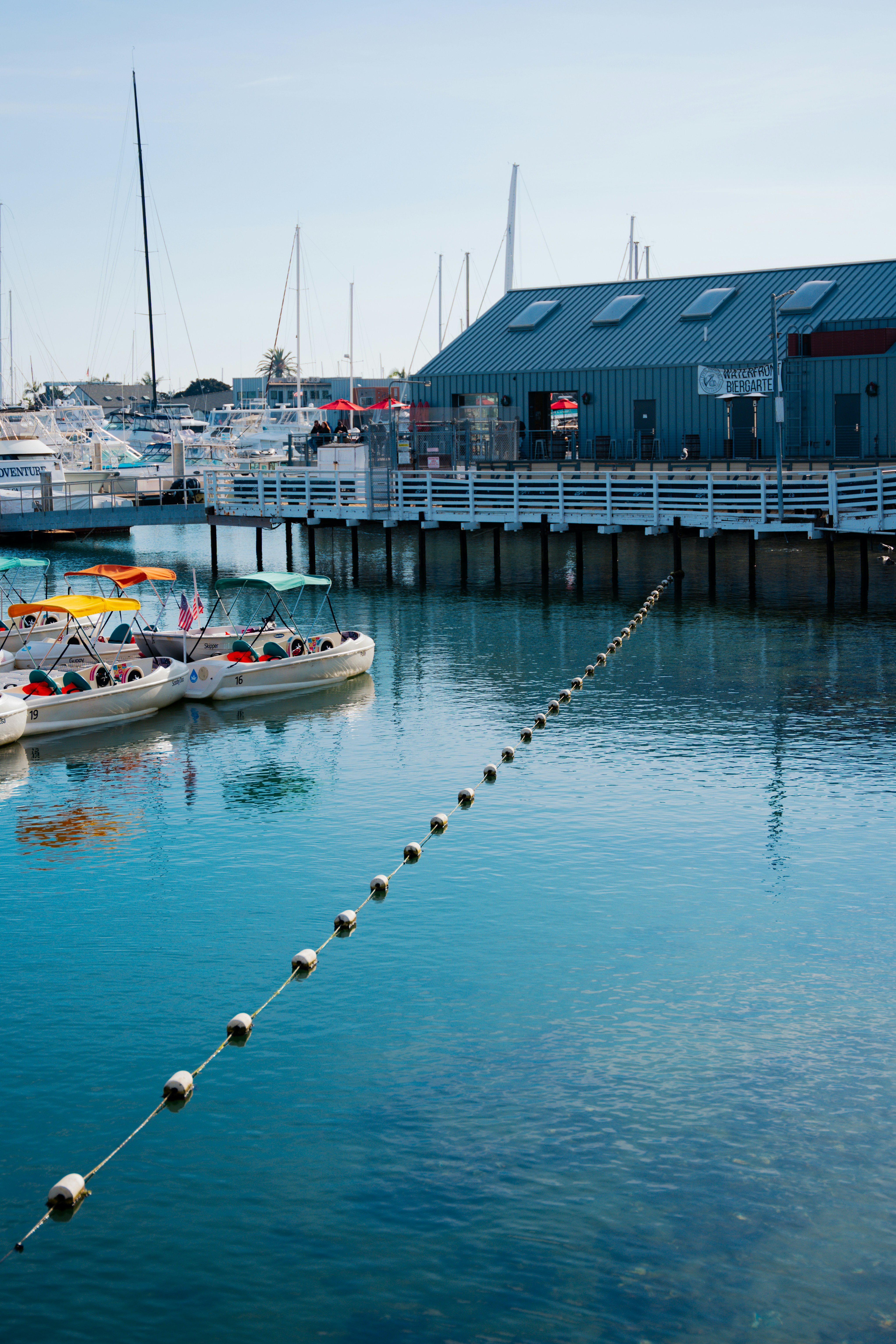 A boat dock with several boats in the water