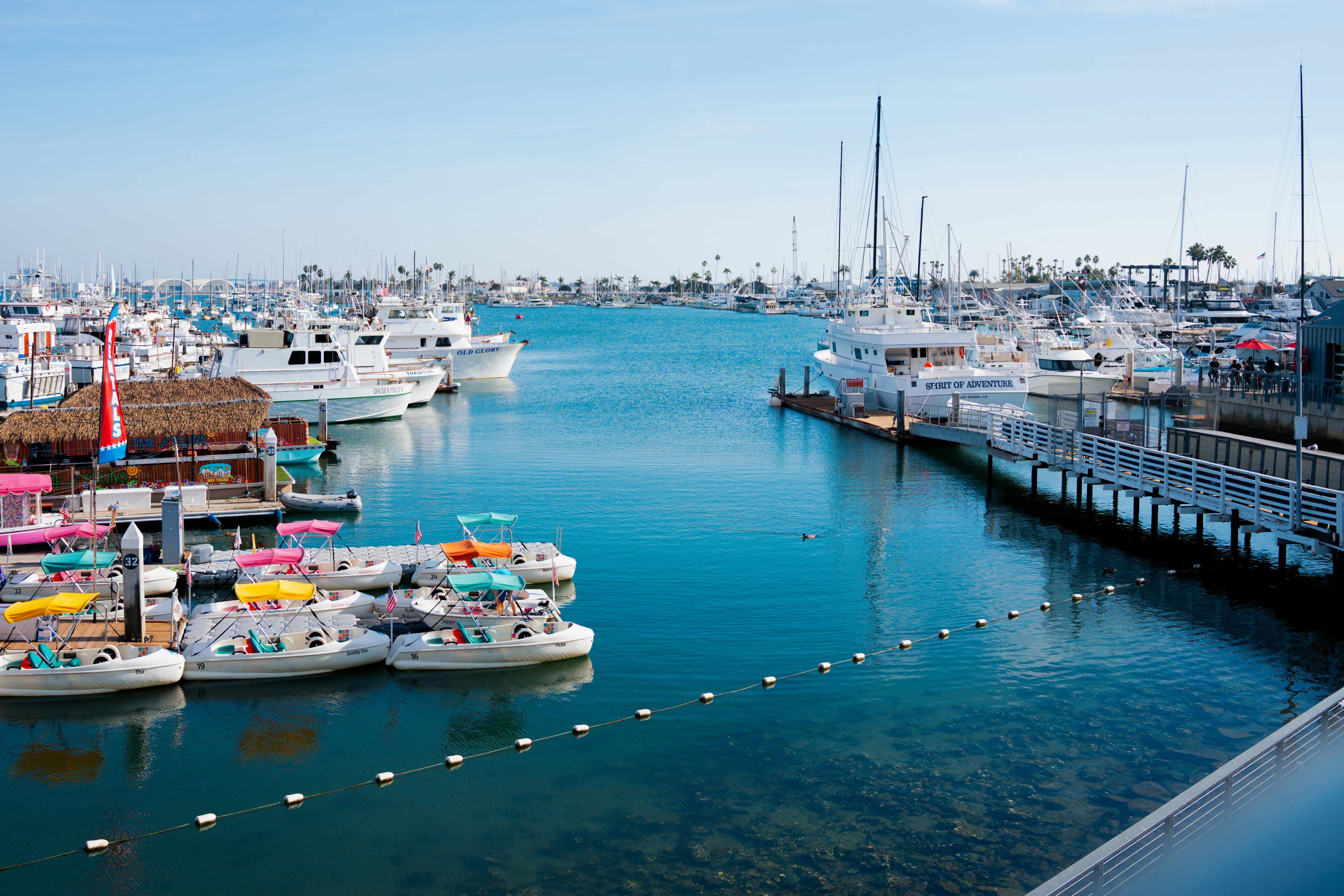 A harbor filled with lots of boats next to a pier