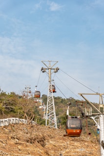 A cable car going up a hill on a sunny day
