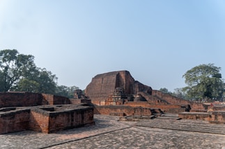 A group of stone structures sitting on top of a dirt field