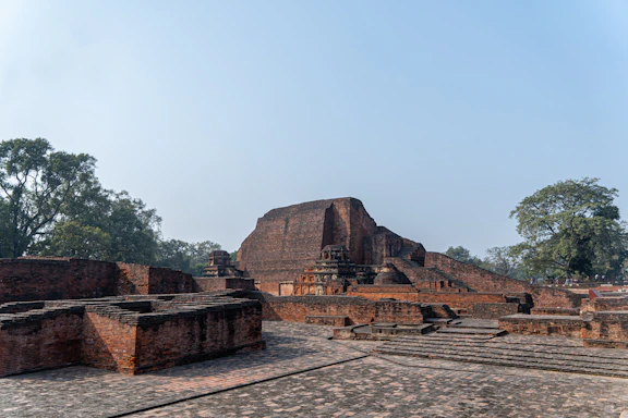 A group of stone structures sitting on top of a dirt field