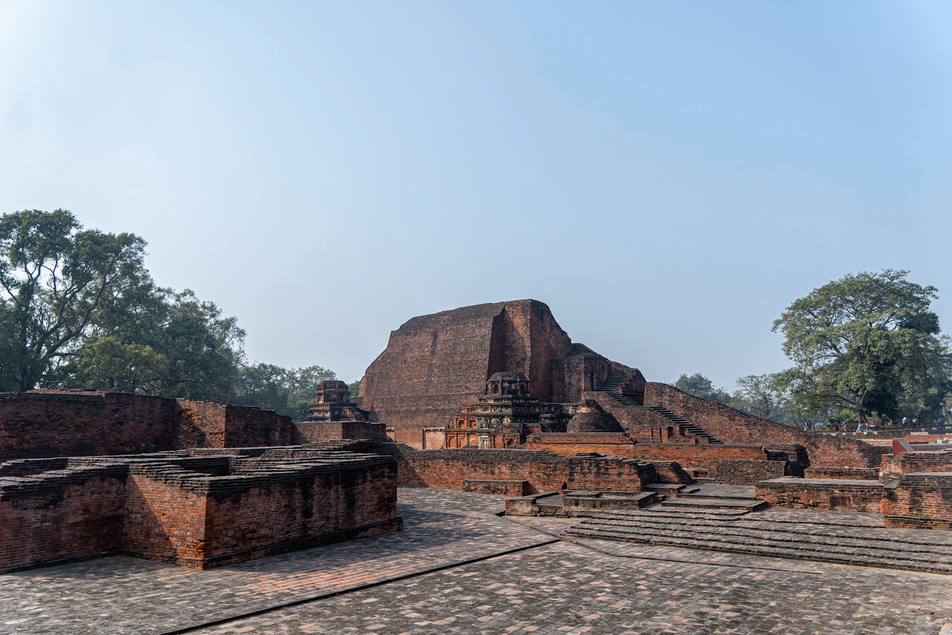 A group of stone structures sitting on top of a dirt field