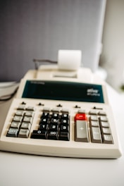 A calculator sitting on top of a white table