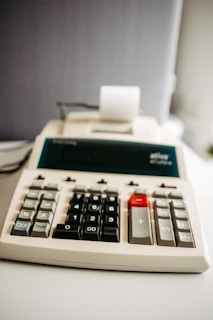 A calculator sitting on top of a white table