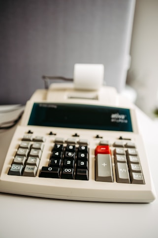 A calculator sitting on top of a white table