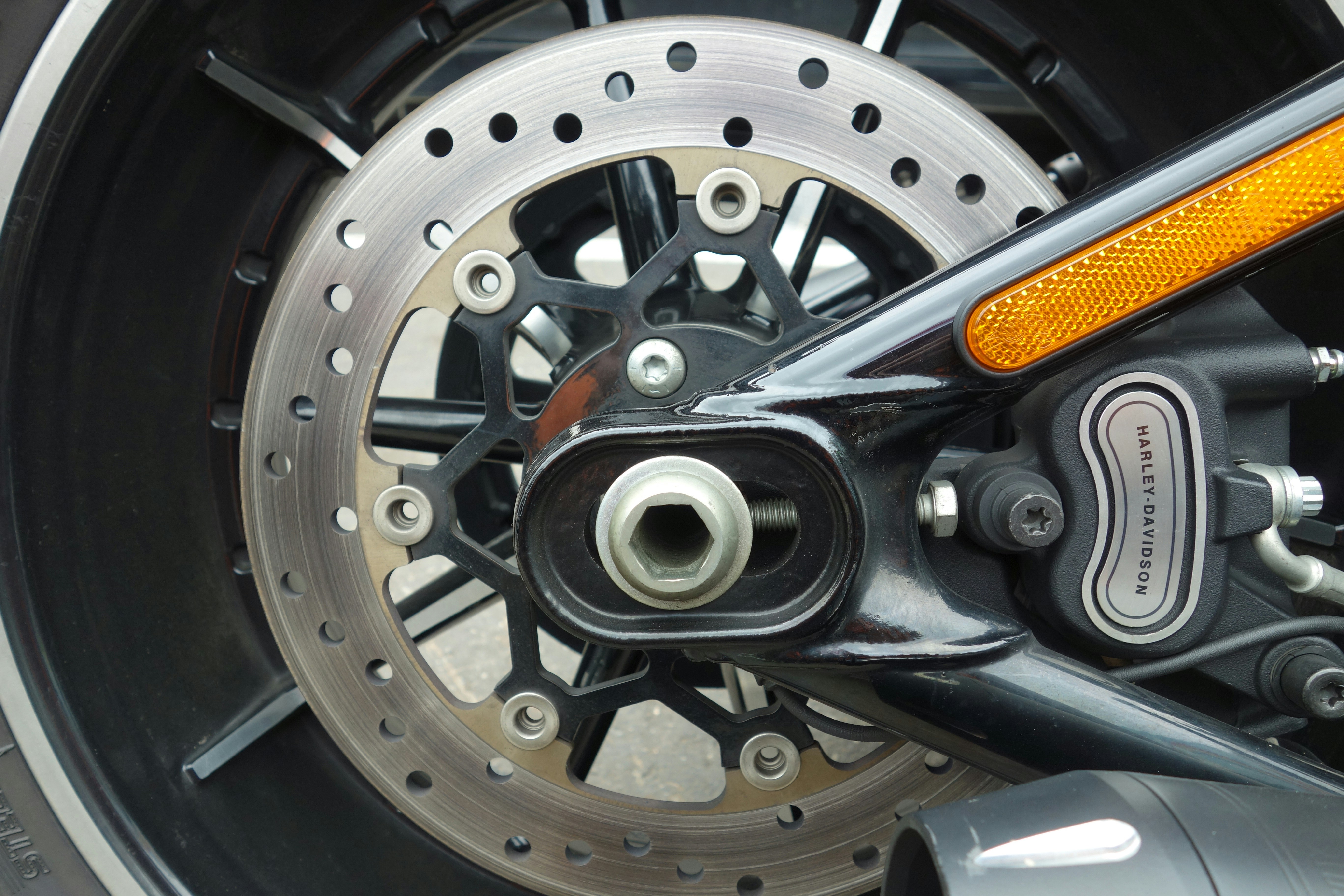 Closeup of an electric vehicle wheel showing the brake disc and caliper behind the rim