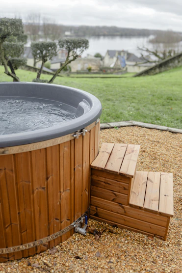 A hot tub sitting on top of a gravel field