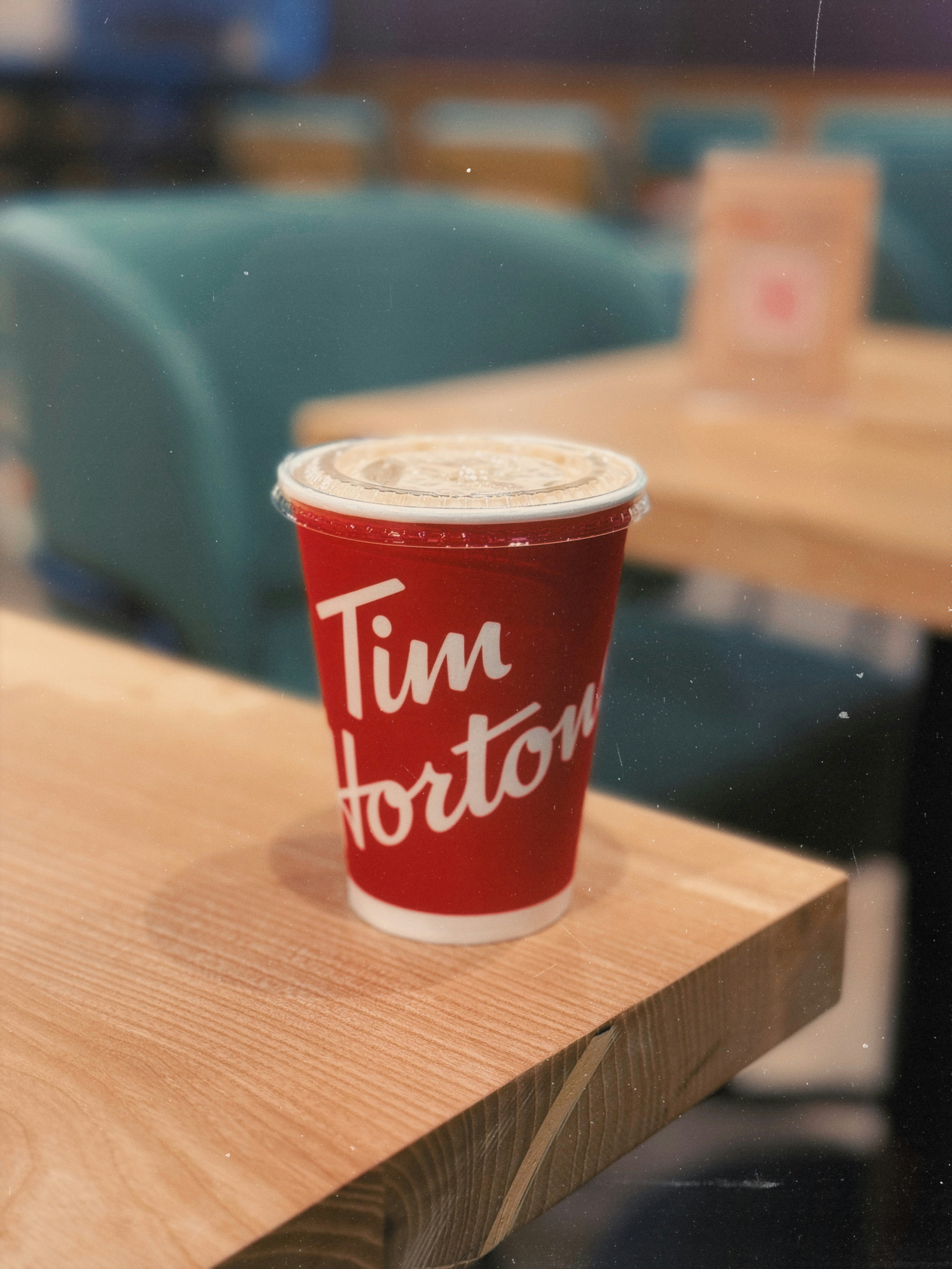 A red cup sitting on top of a wooden table