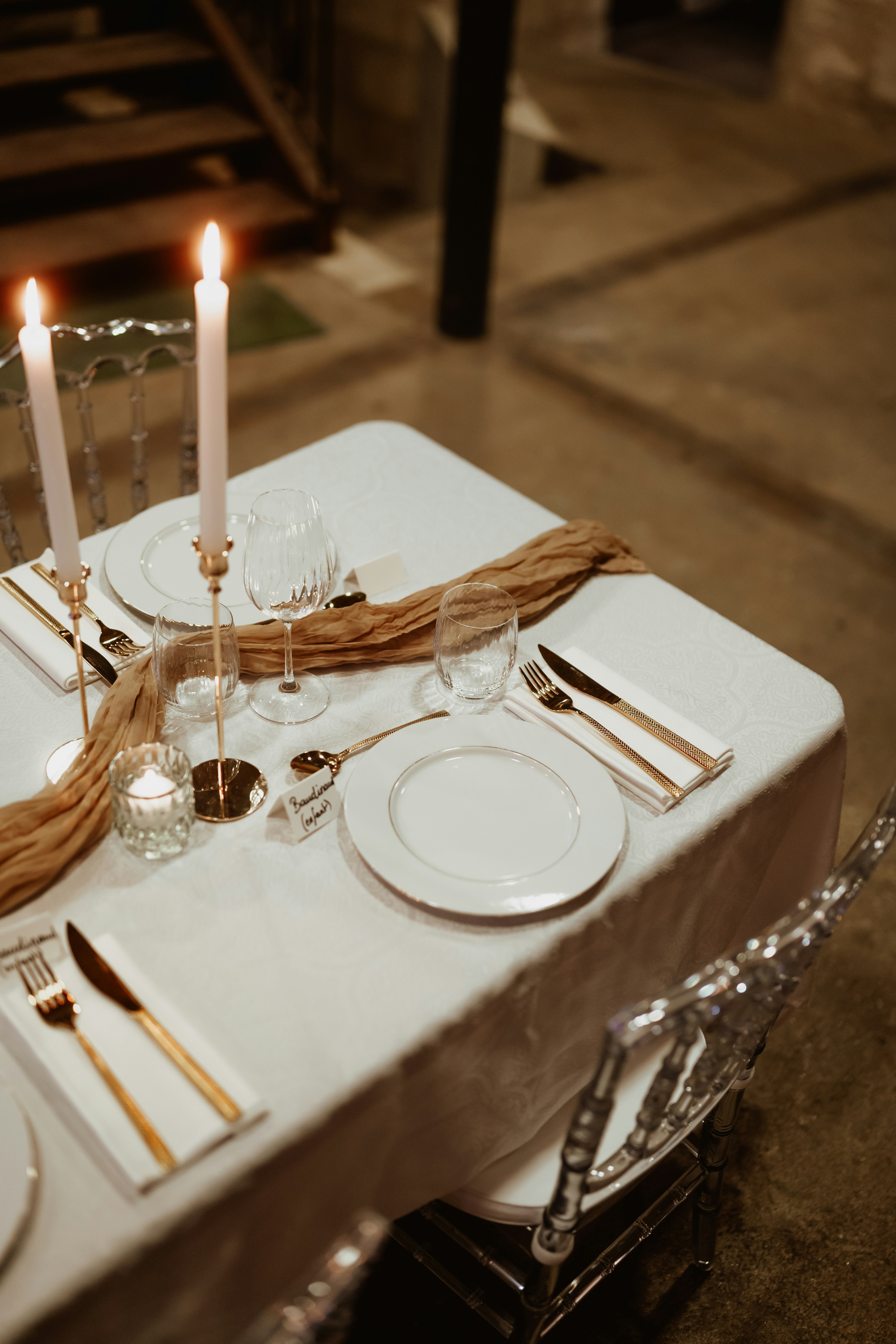 A table set with plates, silverware and candles