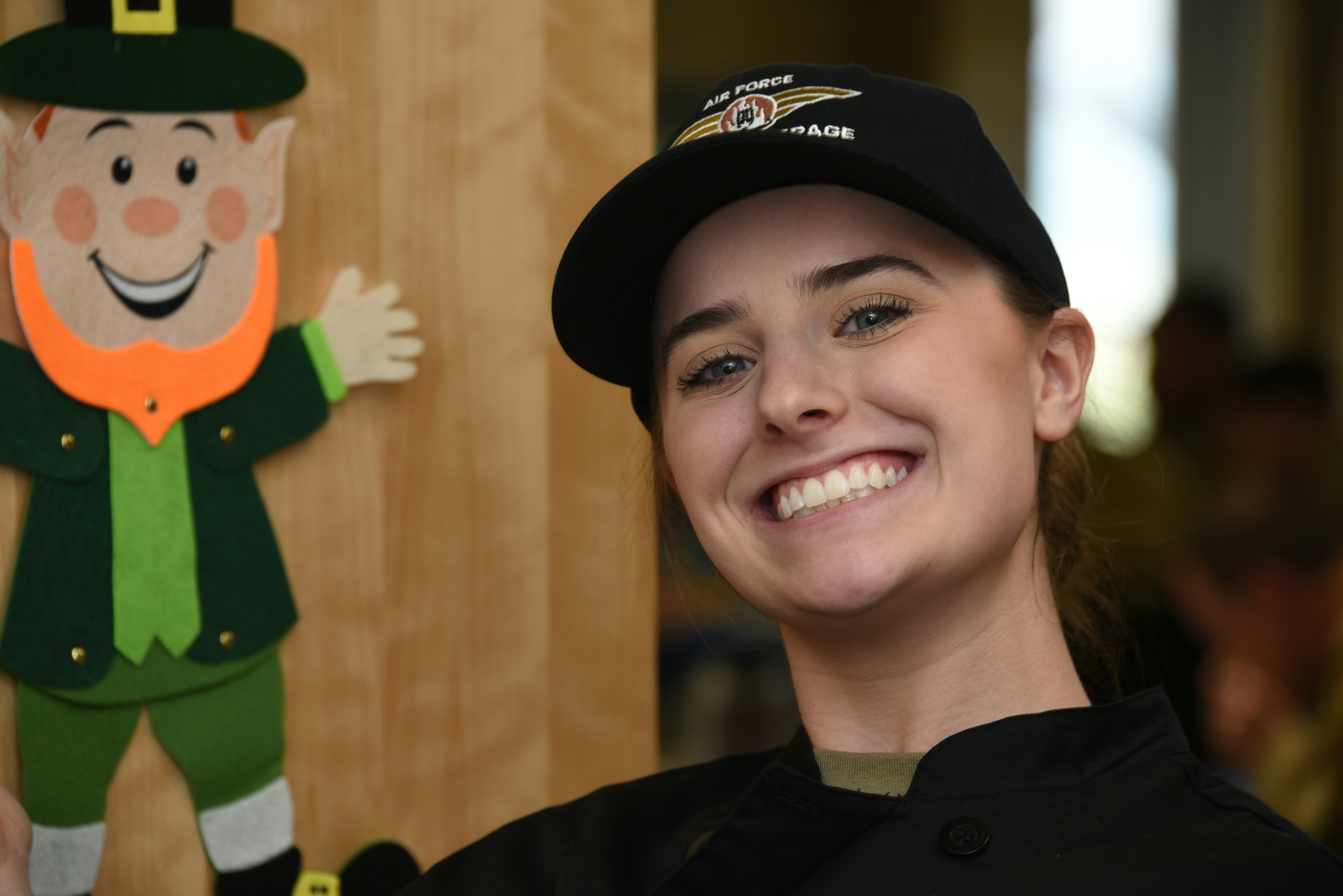 A woman standing next to a cardboard lepreite