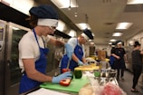 A group of people in a kitchen preparing food