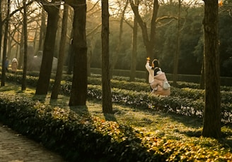 A couple of people that are standing in the grass