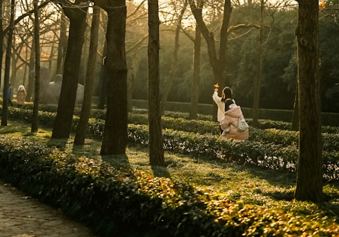 A couple of people that are standing in the grass