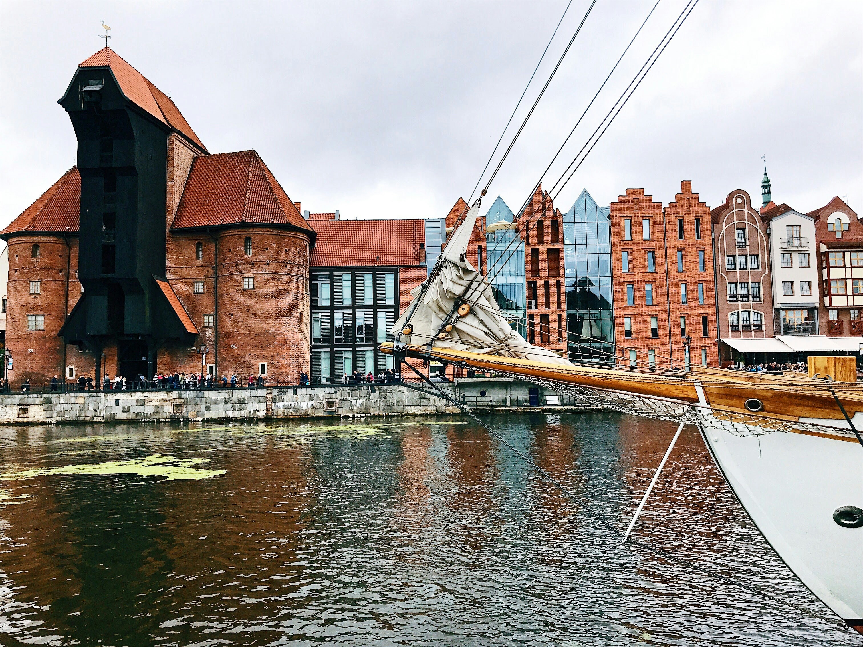 A boat is docked in the water near a building