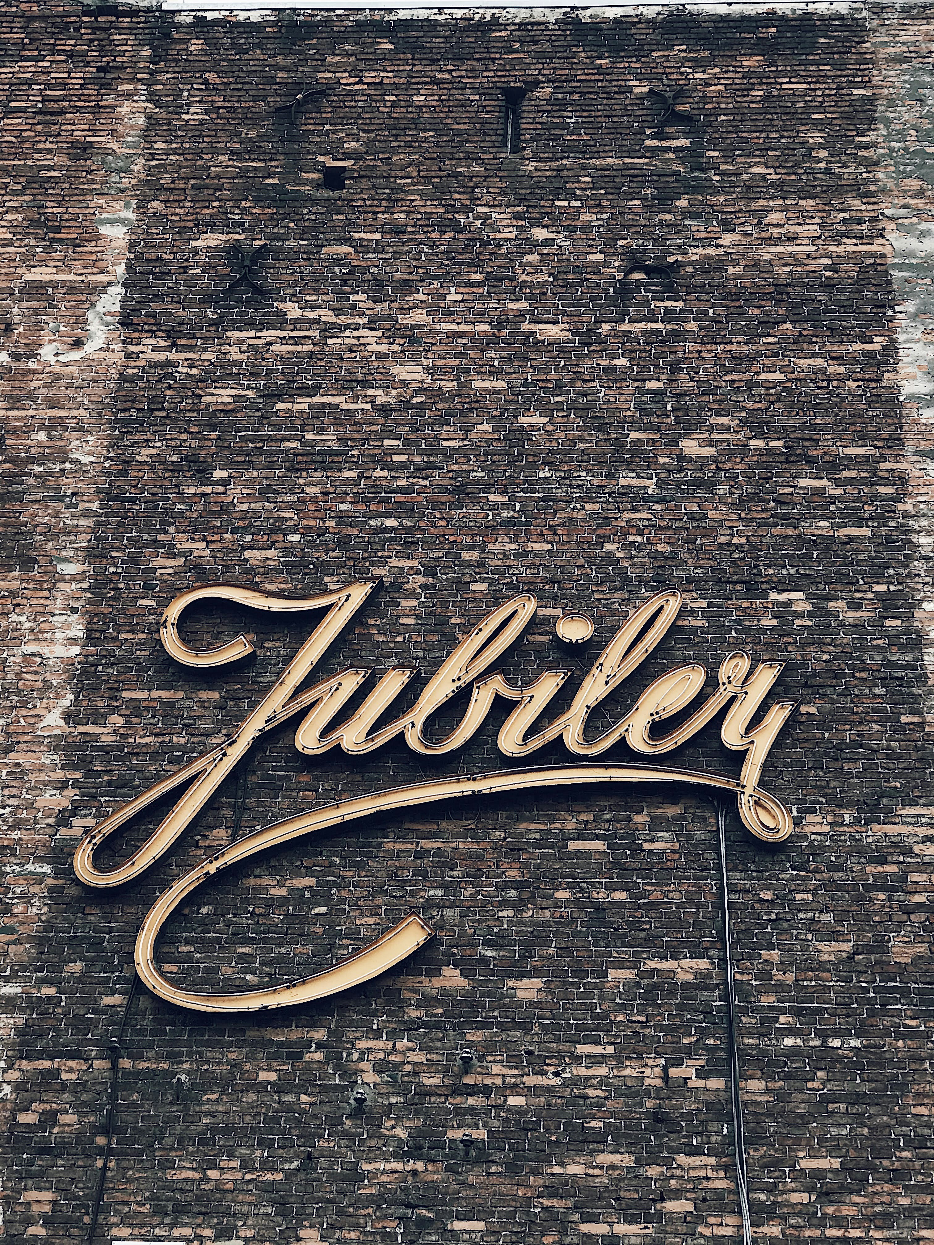 A sign on the side of a brick building