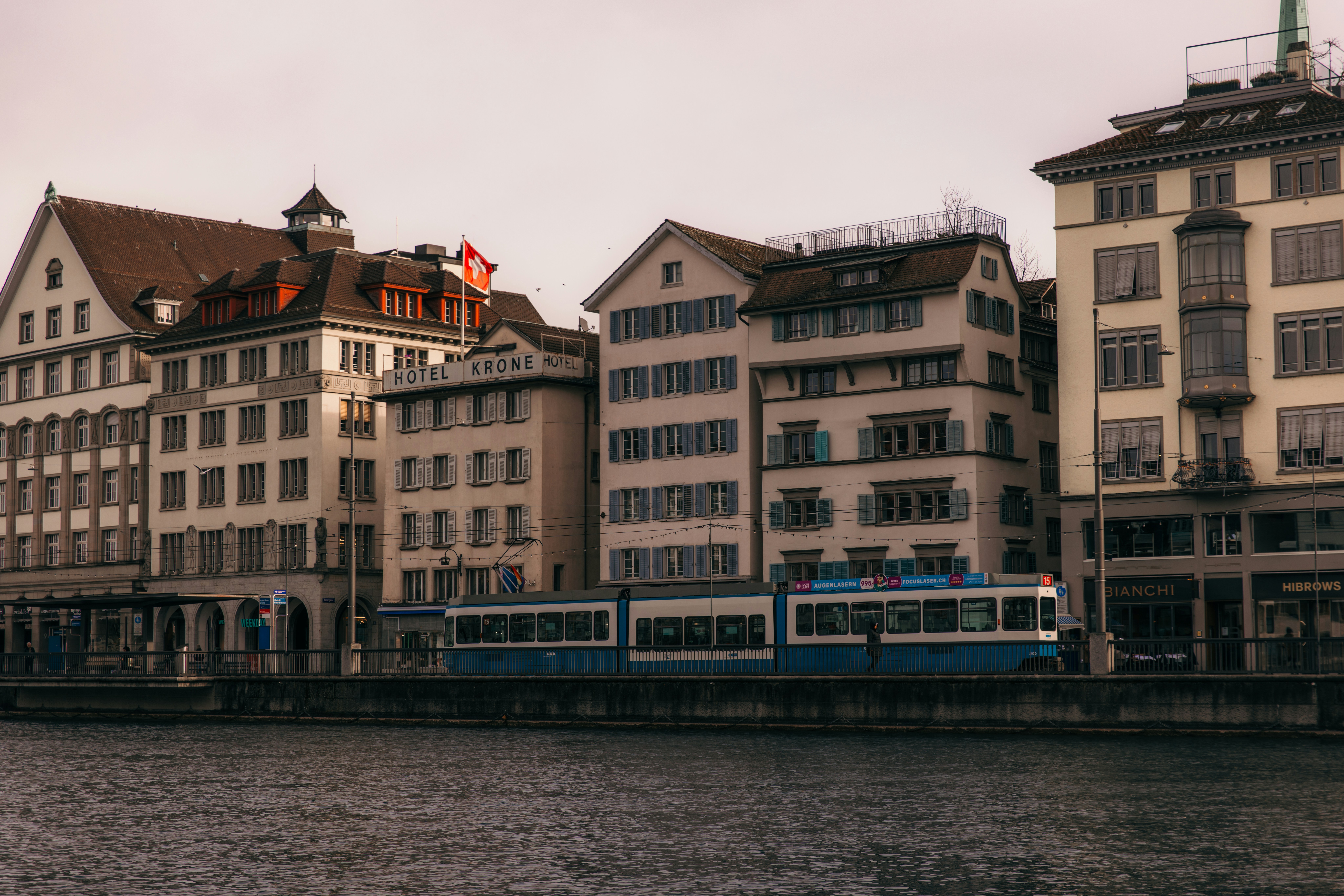 A train on a train track next to a body of water, 