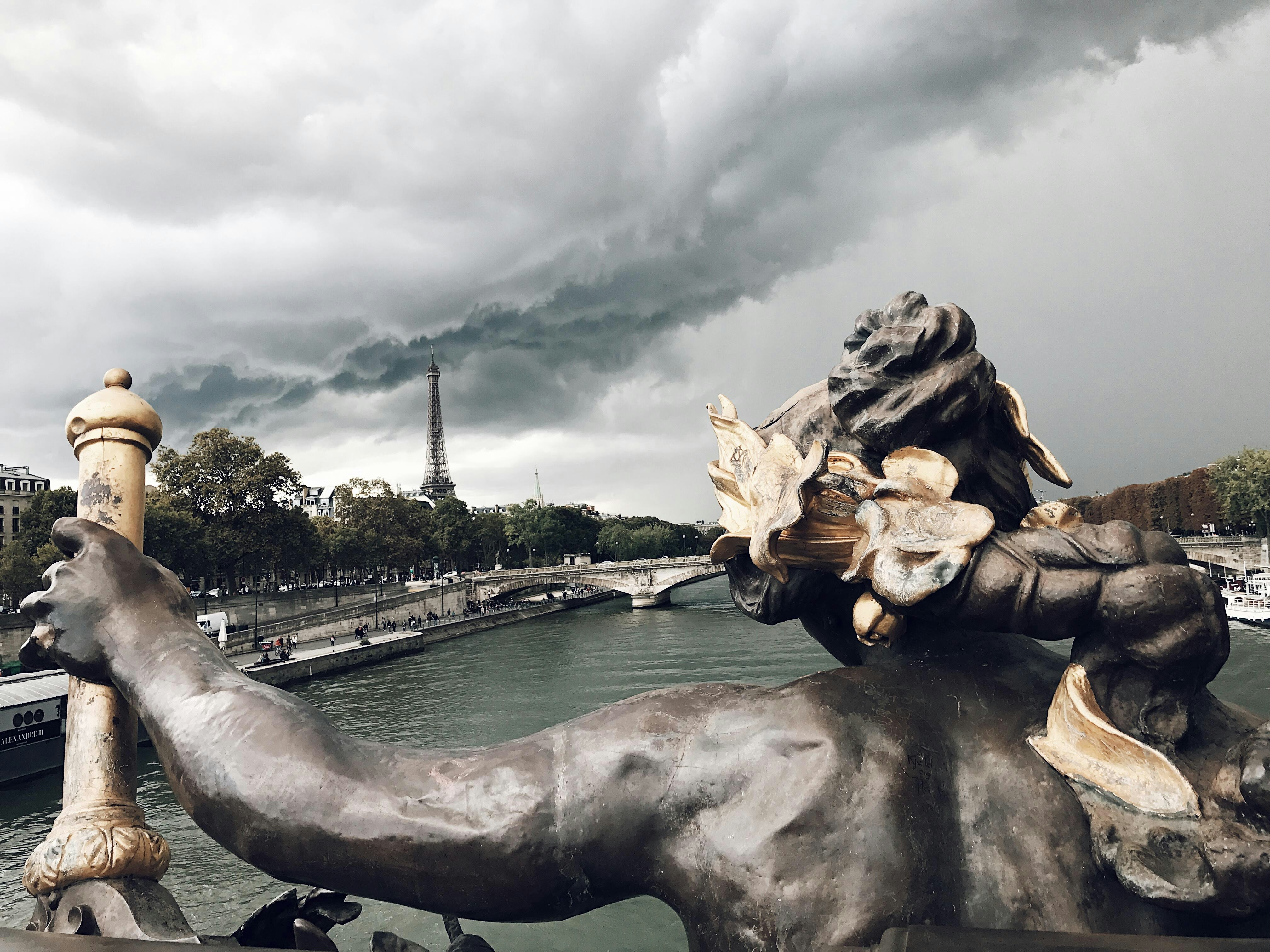 A statue of a horse with a bunch of flowers on its back, 